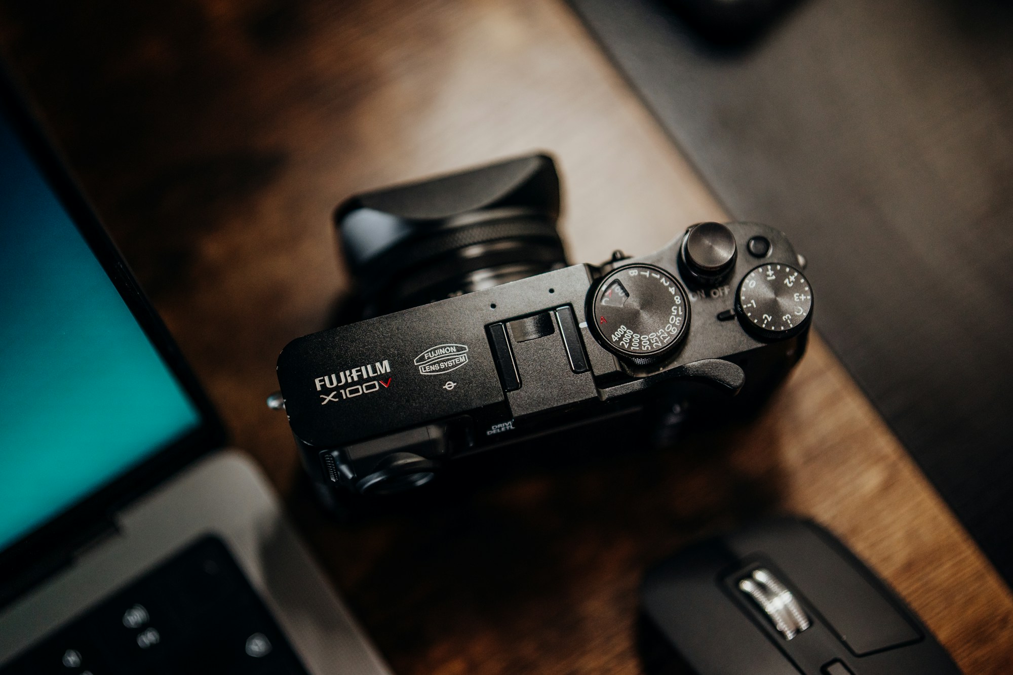 A camera and laptop used for photography and creative production